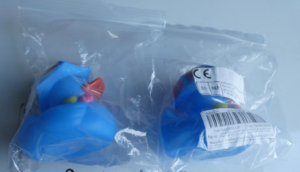 Two blue rubber ducks in plastic packaging.